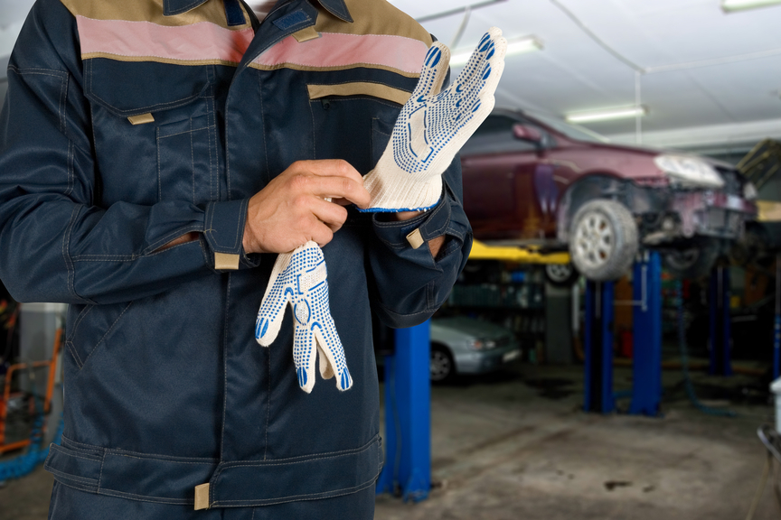 Auto mechanics closeup standing in his workshop